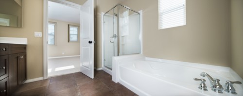 Contemporary bathroom with bath and glass shower at home