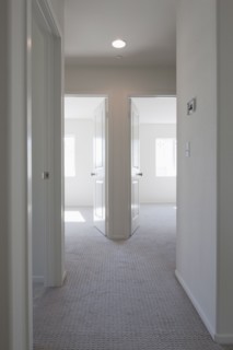 Empty room with open doors and hallway at home