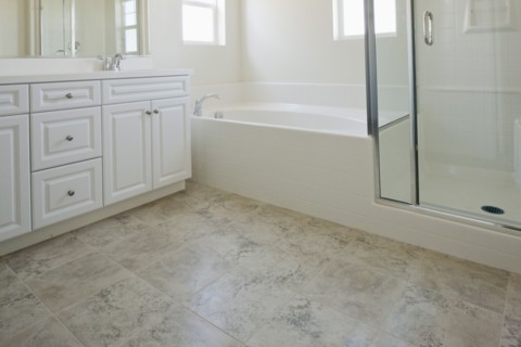 Bathroom with bath and cabinets at home