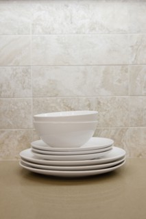Close-up of bowls with plates in the shelf