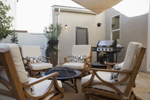 View of sitting area with barbecue at a patio