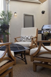 View of sitting area with barbecue at a patio