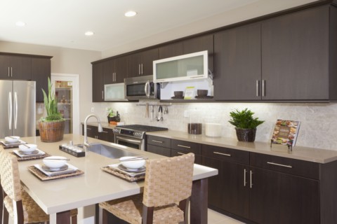 Kitchen having brown cabinets and island at home
