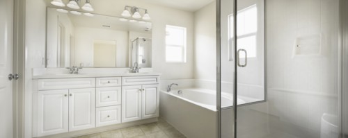 Bathroom with bath and cabinets at home