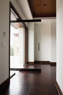 Hallway with wooden floor and open glass door