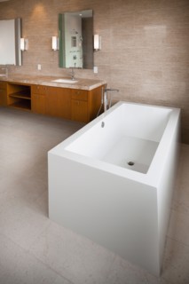 Contemporary bathroom with bath and cabinets at home