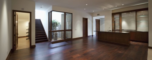Empty house with kitchen area and wooden floor