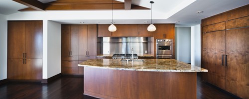 Kitchen having brown cabinets and island at home