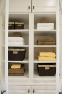 View of folded towels and baskets in shelf at home