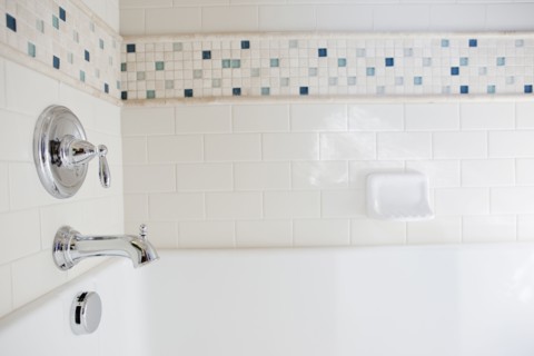Close-up of shower taps in bathroom at home
