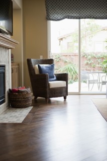 Wicker armchair on hardwood floor in living room
