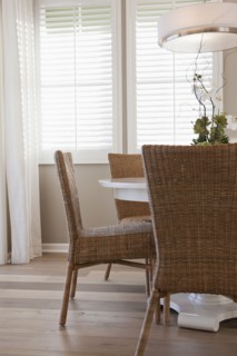 Wicker chairs at dining table in middle class house