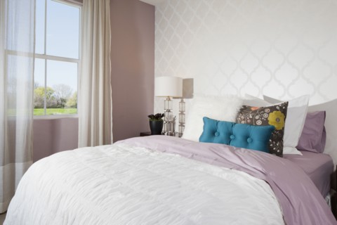 Throw pillows arranged on bed in average house