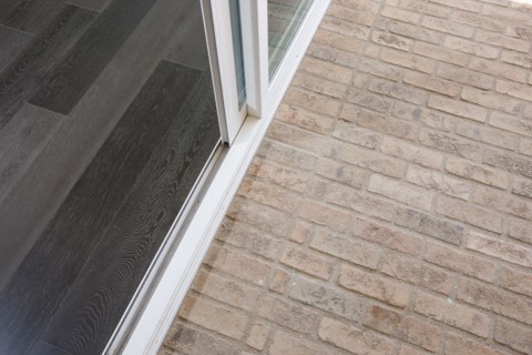 High angle view of stone flooring and sliding door at porch