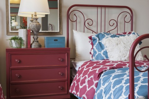 Night table and wrought bed in middle class bedroom