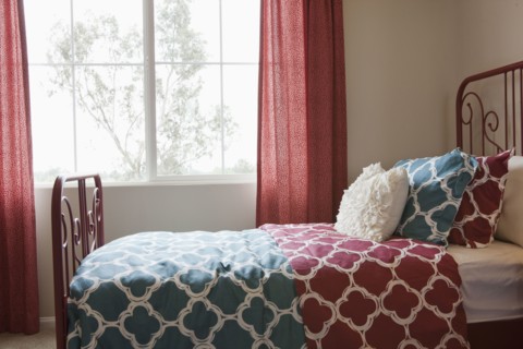 Pillows arranged on bed in middle class house