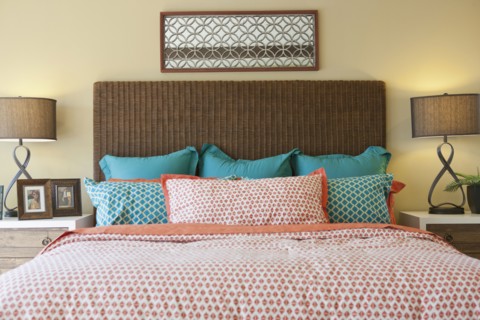 Blue and pink pillows arranged on bed