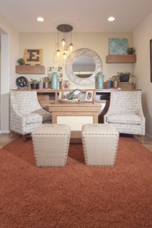 Chairs and footstools in seating area of house