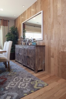 Sideboard with mirror mounted on wooden wall