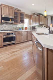 Hardwood floor and wooden cabinets in kitchen