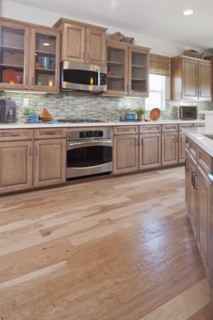 Hardwood floor and wooden cabinets in kitchen