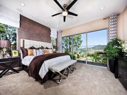 Interior of bedroom with bed end ottoman