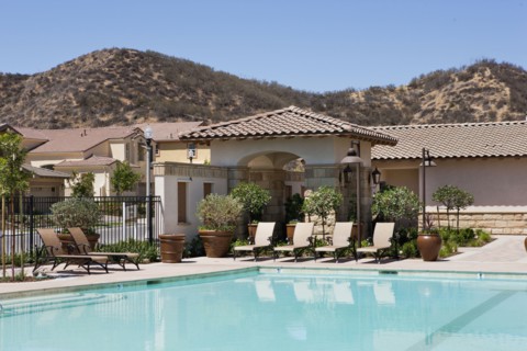 Outdoor swimming pool and deck chairs at community center