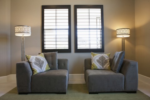 Floor lamps with sitting furniture against window