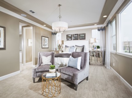 Spacious bedroom with sitting area in foreground at home