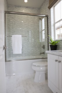 Contemporary bathroom with glass shower and commode at home