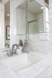 Contemporary bathroom with marble washbasin and mirror at home