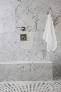 White towel and tap on marble wall in the bathroom at home