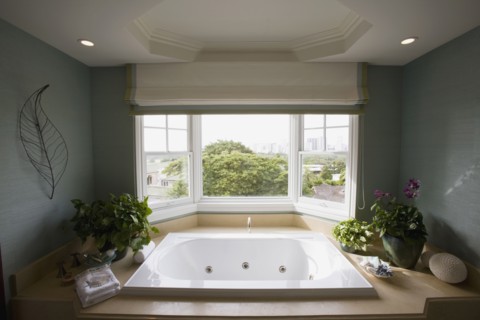 Large hot tub bathtub near window
