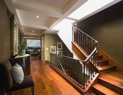 Modern hardwood staircase with wrought iron banister