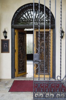 Wrought iron gate and hand carved wooden door