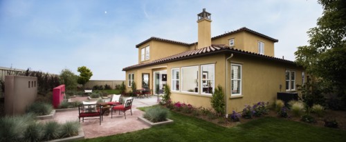 Contemporary patio behind Spanish style home