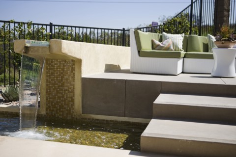 Contemporary fountain along patio