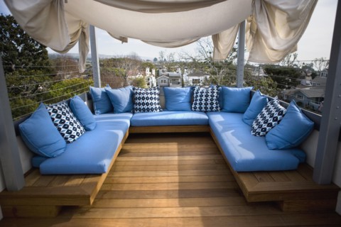 Rooftop sitting area with blue cushions
