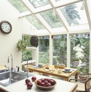 Apples in bowl in traditional kitchen with dining table