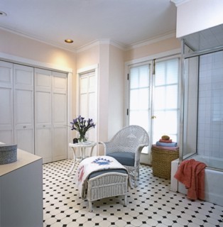 White wicker chair and ottoman with blue grey cushions