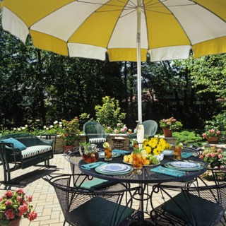 Close up of umbrella table and surrounding wicker furniture