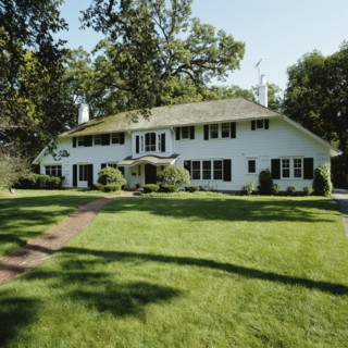 Large graceful symmetric white frame house