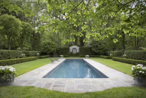 Formal shaped hedge garden with narrow pool
