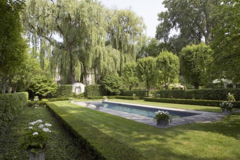 Formal shaped hedge garden with narrow pool