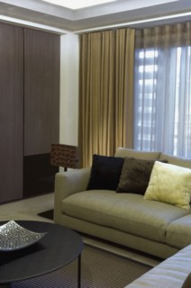 Detail contemporary sofa in front of window with drapes