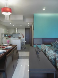 Modern living room dining room and kitchen with teal accents