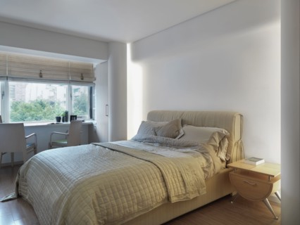 Contemporary bedroom with desk near window
