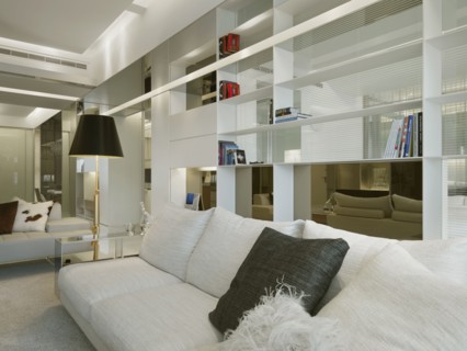 Modern sofa in front of bookshelf