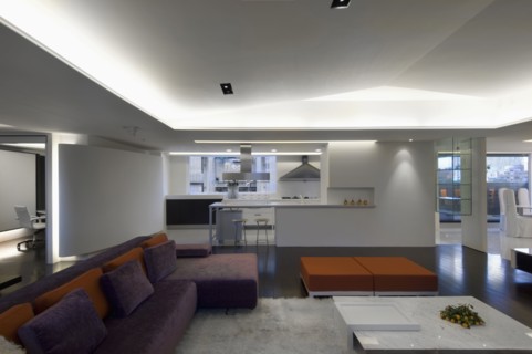 Spacious modern interior with purple and orange sofa