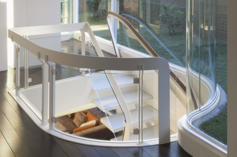 Modern white staircase with glass banister